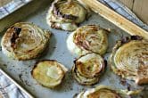 cooked cabbage steaks on a baking sheet
