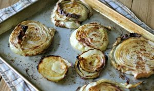 cooked cabbage steaks on a baking sheet