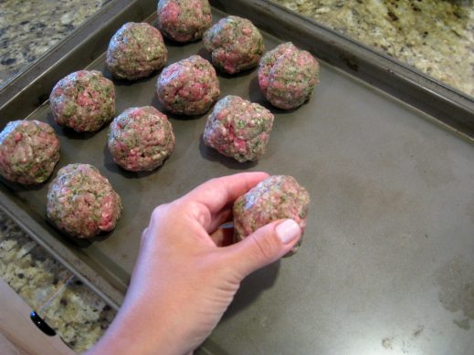 rolling pesto meatball mixture into evenly sized balls