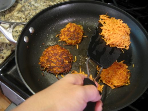 flipping sweet potato latkes to cook the other side