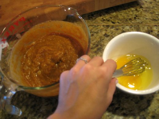 beating eggs until bubbly to pour into glass measuring cup with paleo pumpkin pie filling
