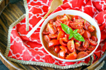 bowl of tomato salad made with jersey tomatoes with basil on top