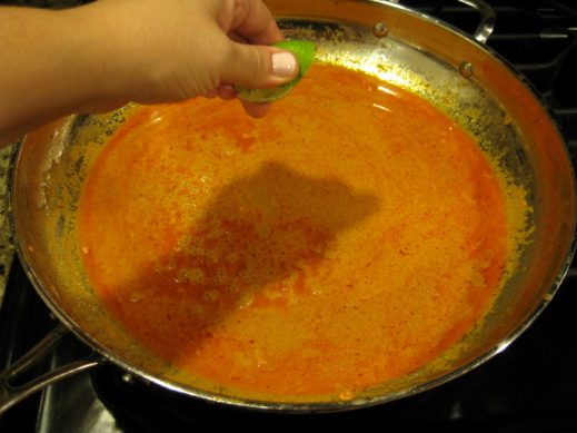 reducing the curry sauce for curry salmon in a large skillet