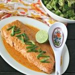 whole fillet of wild salmon in red curry sauce with lime and bowl of broccoli