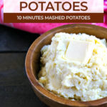 wood bowl of mashed potatoes made in the instant pot topped with a tab of butter