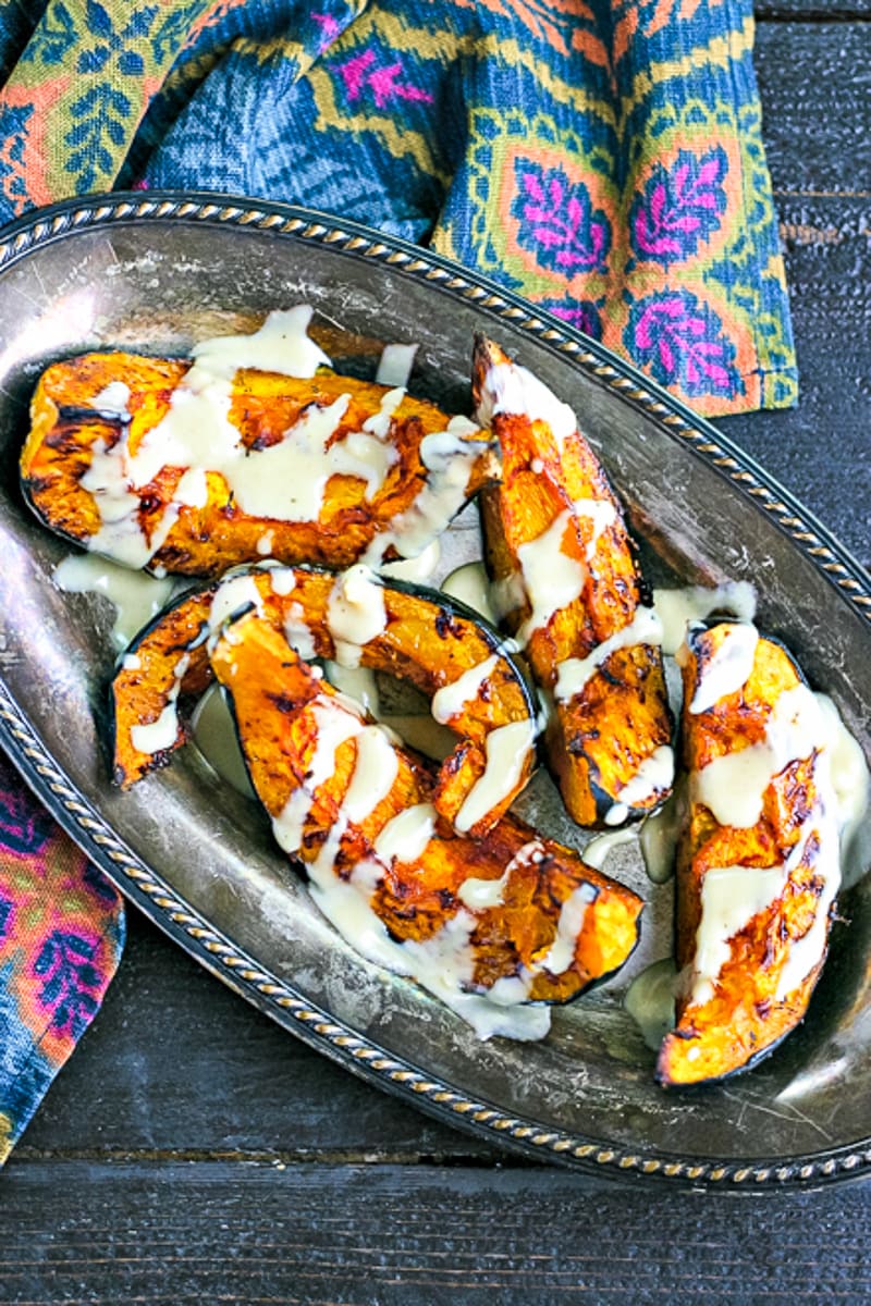 overhead view of roasted acorn squash with tahini drizzle