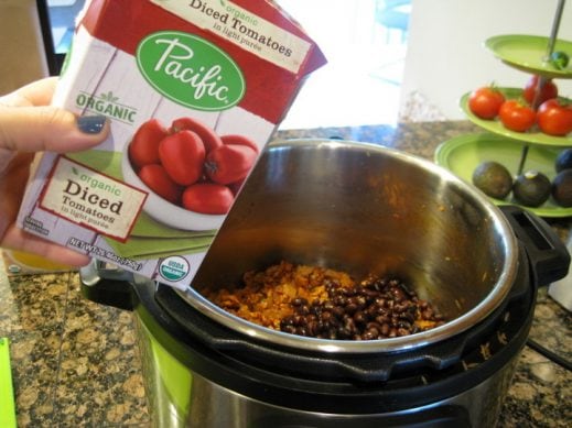 Adding Pacific Foods Organic Diced Tomatoes to Taco Soup from www.EverydayMaven.com