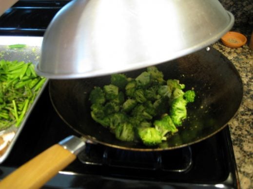 cooking broccoli florets in a wok
