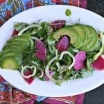 oval white platter with watercress salad, avocado, fennel and watermelon radish