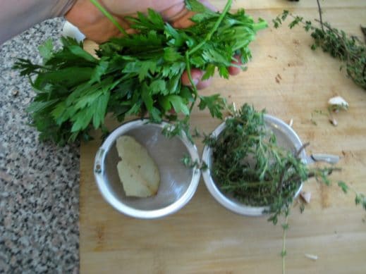 fresh parsley, fresh thyme and dried bay leaf stuffed into a metal spice ball to flavor soup broth