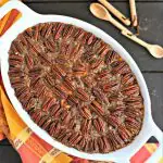 overhead shot of white casserole dish with pecan topped healthy sweet potato casserole