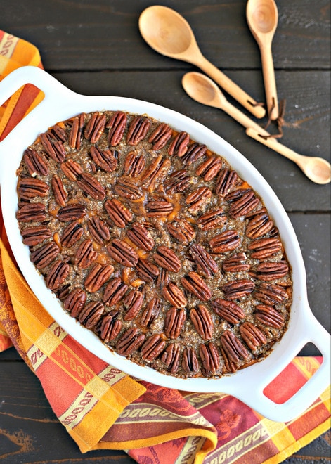 overhead shot of white casserole dish with pecan topped healthy sweet potato casserole