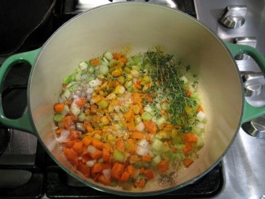 cooking diced onion, celery, carrot, spices and fresh thyme in a large soup pot