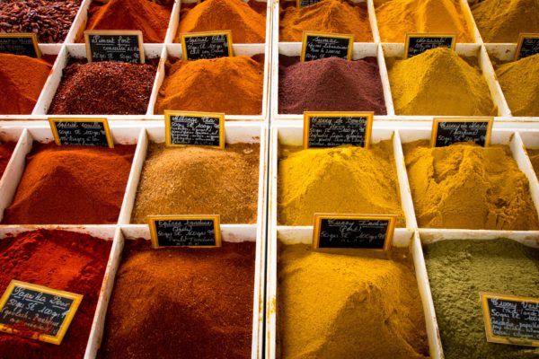 bins of different colored spices 