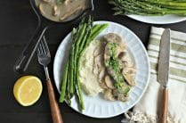 white dinner plate with asparagus, mashed cauliflower and instant pot poached chicken breast with creamy mushroom sauce