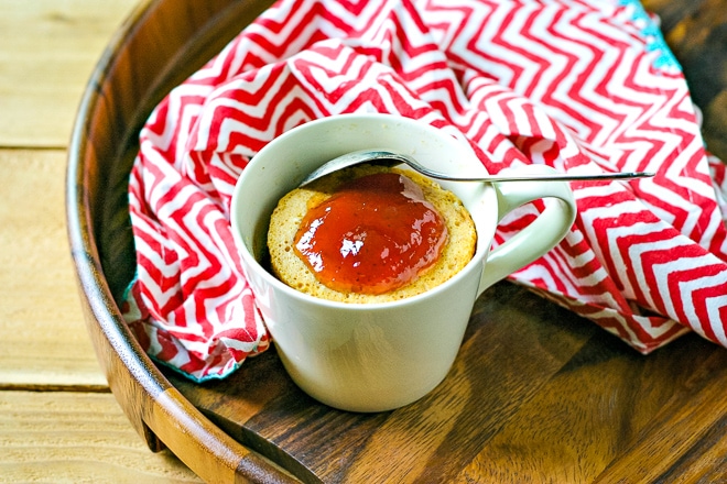 peanut butter mug cake on a tray with a red striped napkin