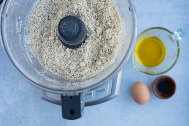 adding almond flour and other dry ingredients to a food processor for gluten free scones recipe