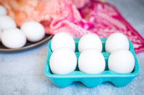 white eggs in a blue ceramic egg holder for coddled eggs