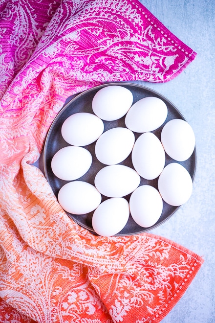platter of white eggs with colorful linen for coddled eggs
