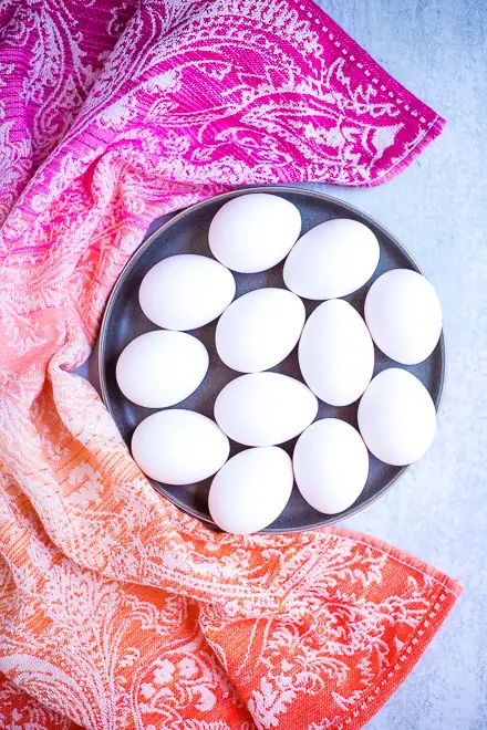 platter of white eggs with colorful linen for coddled eggs