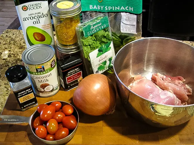 ingredients to make paprika chicken on a cutting board