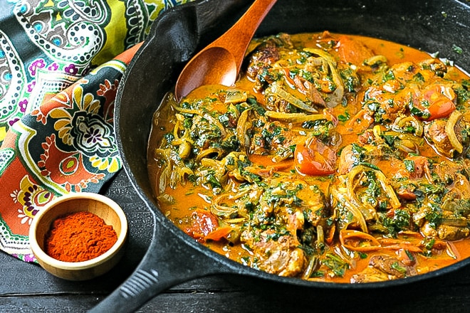 cast iron skillet with paprika chicken ready to serve