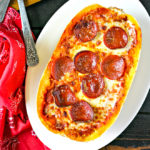 spaghetti squash topped with sauce, melted cheese and pepperoni for low carb pizza boats