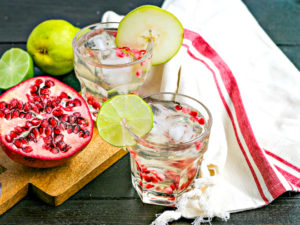 winter sangria with a red and cream striped linen and pomegranate cut in half