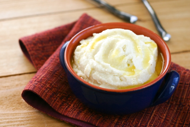ceramic bowl with mashed cauliflower topped with melted ghee