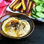 wood bowl with instant pot hummus topped with spices