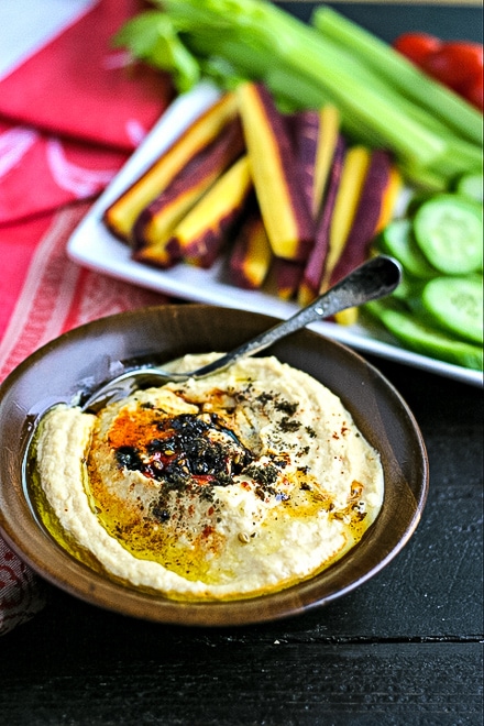 small bowl of hummus with fresh cut vegetables for serving