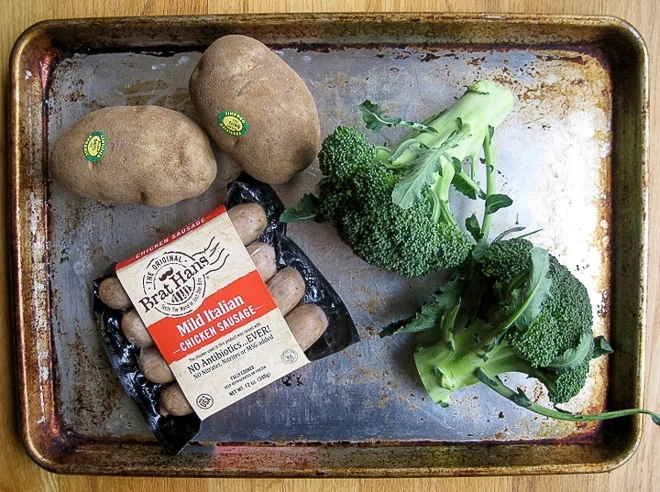 uncooked ingredients to make sausage sheet pan dinner