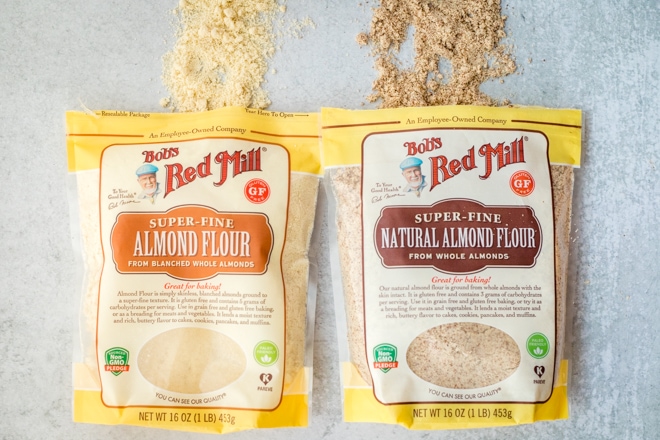 a bag of bob's red mill almond flour next to a bag of bob's red mill natural almond flour showing the difference between the types of flour
