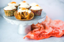 silver cake stand with carrot muffins and an orange linen