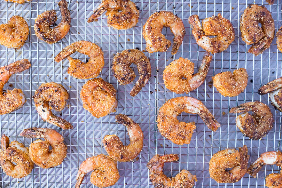 breaded cooked shrimp on a cooling rack