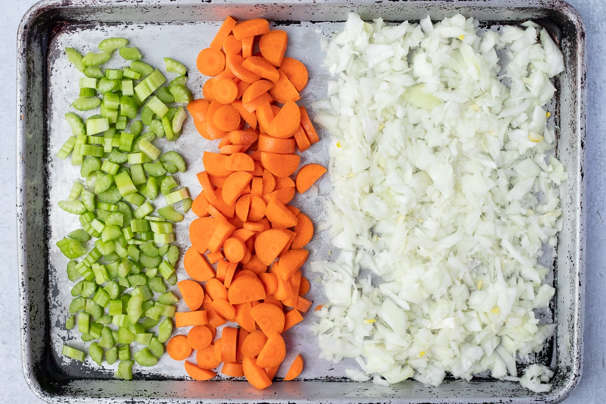 diced celery, carrot and onion on a baking sheet