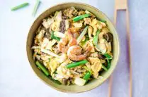 glass noodle stir fry with cabbage, mushrooms and scallions in a serving bowl