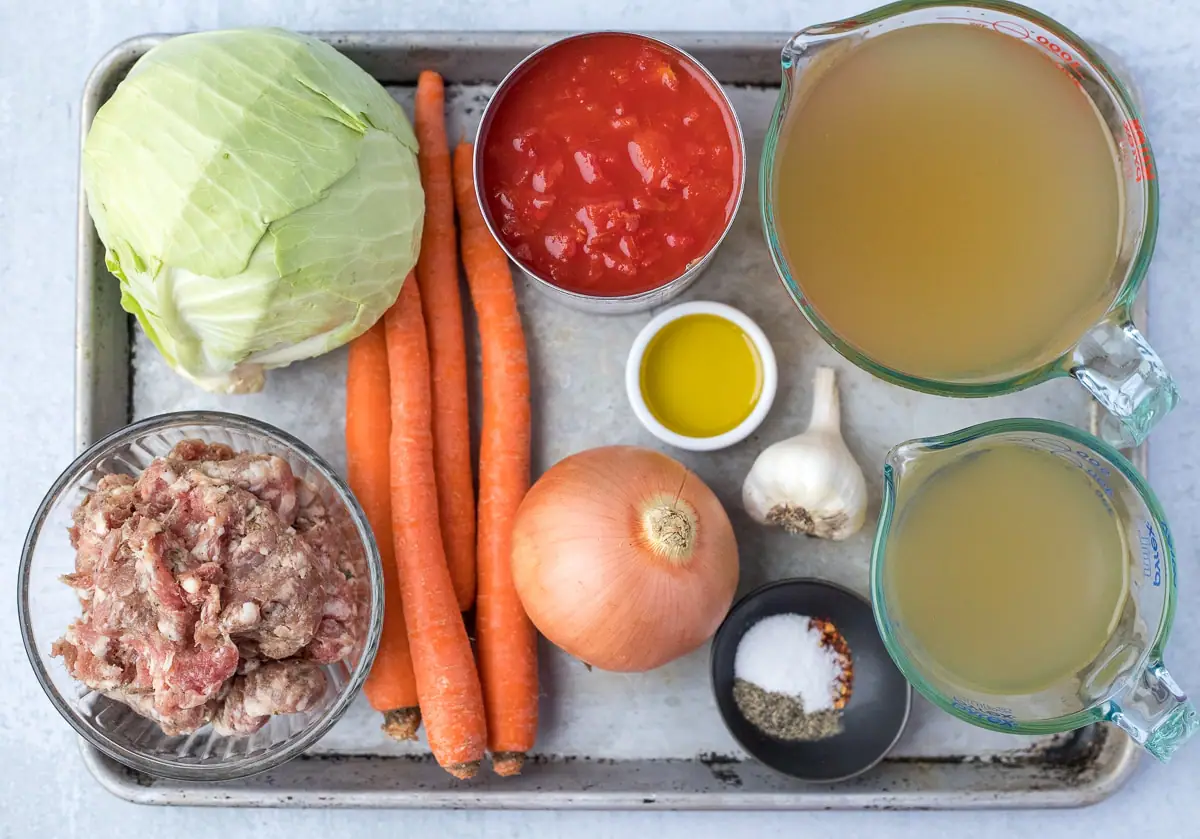 baking sheet with ingredients on it to make sausage and cabbage soup