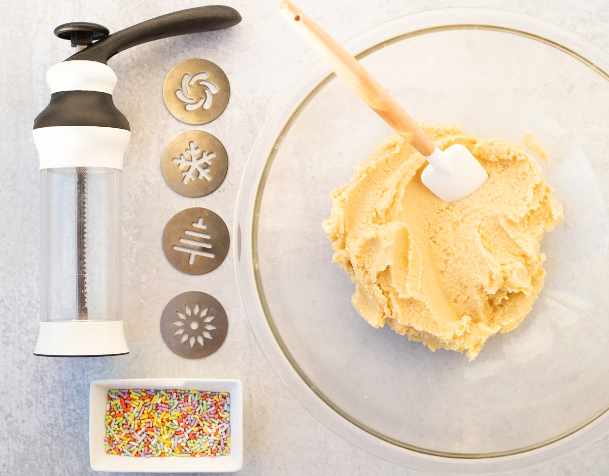 butter cookie dough next to cookie press