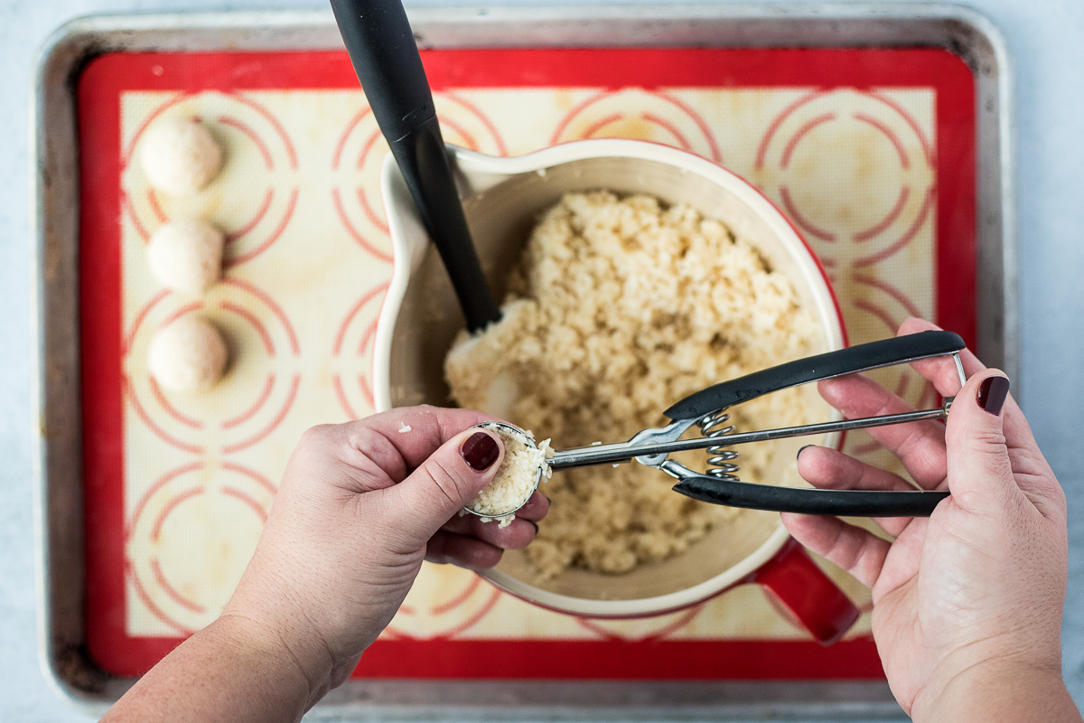 packing coconut macaroon batter into a cookie scoop