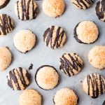 close up of mini macaroons. some plain, some drizzled with dark chocolate and some dipped into dark chocolate